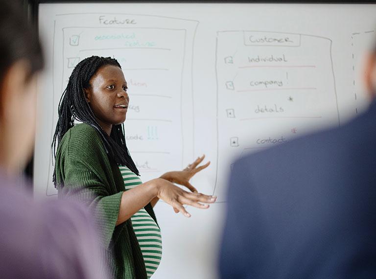 Pregnant team member gives presentation
