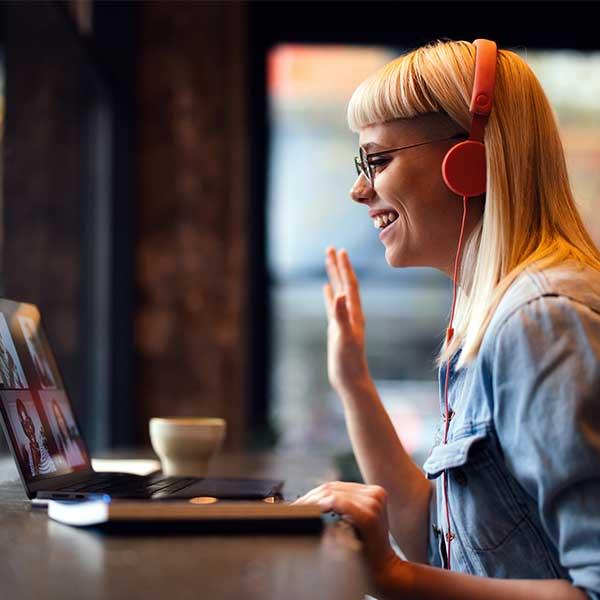 Permalancer waving at their team members working remotely