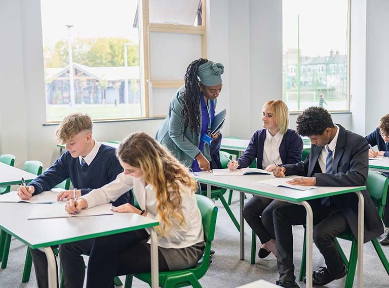 Teacher who has returned to her teaching career in classroom