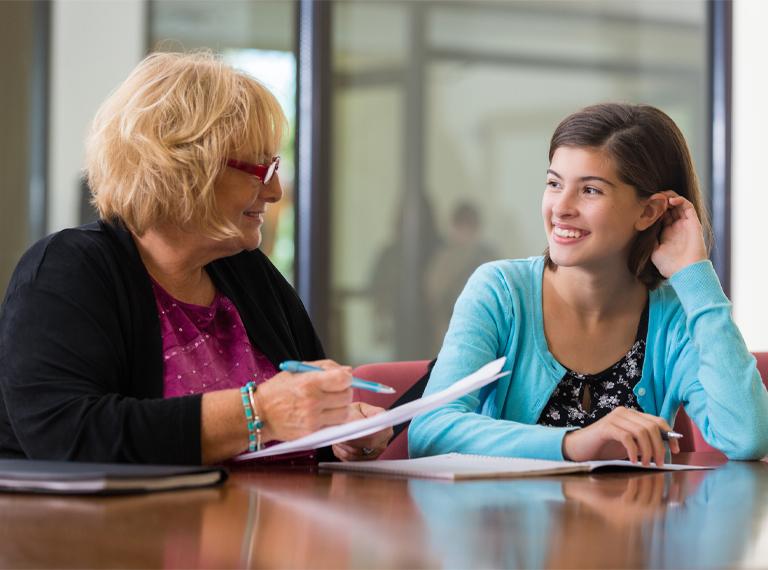 Preteen girl meeting with school counsellor or therapist