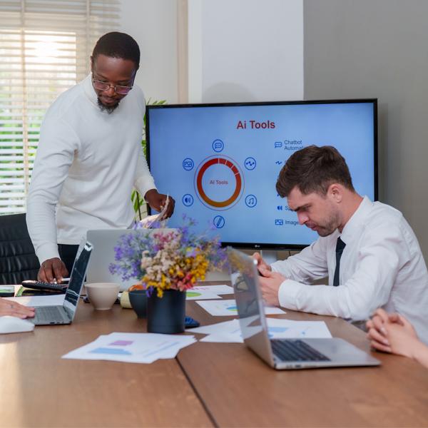 An in modern business setting, team collaborates on technology and marketing strategies, utilising ai tools for analysis and innovation. Atmosphere is focused and productive.