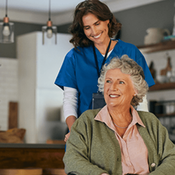Carer helping woman in her home