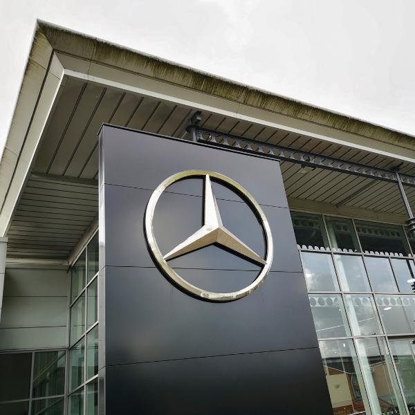 Mercedes showroom with logo. Mercedes-Benz, commonly referred to as Mercedes is known for producing luxury vehicles and commercial vehicles. The headquarters is in Stuttgart, Baden-Württemberg.