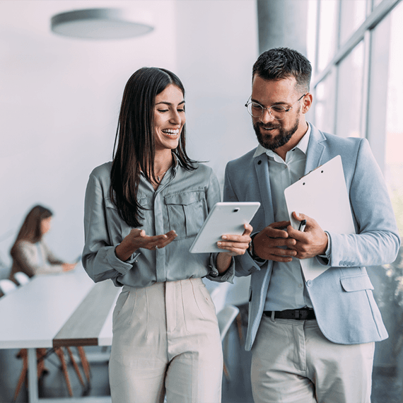 Two co-workers talking and smiling