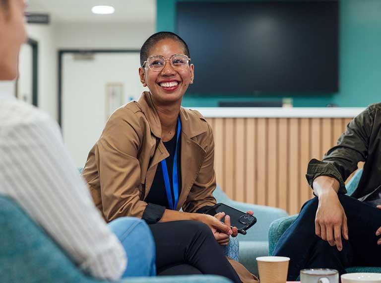 Employee talking to colleagues smiling