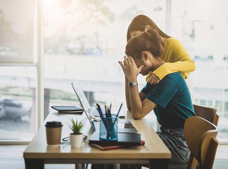 Colleague supporting coworker