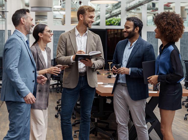 Businesspeople talking while standing in office during break. Teamwork concept. High quality photo