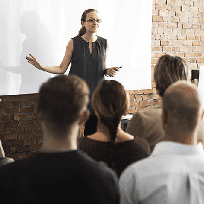 Woman giving a speech to a group of people